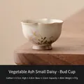Ceramic ash-glazed daisy flower bud teacup with pink floral pattern on wooden table - Hand-Painted Daisy - Grass Ash Glaze Bud Cup