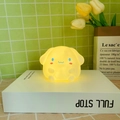 Yellow Cinnamoroll character night light emitting warm glow on a white box - Fat Cinnamoroll