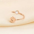 Detailed close-up of rose gold open ring with crystal inlay and hollow cat paw design - US 6