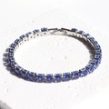 Macro view of sapphire blue tennis bracelet with silver plating and round-cut crystals - Blue Zirconia