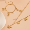 Golden stainless steel ocean theme jewelry set with starfish, seashell and pearl charms - Starfish Zirconia Beach Jewelry Set (T703-T705)