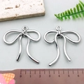 Silver bow-knot alloy pendant charms for DIY jewelry making shown with size reference - Large Bowknot - Silver