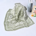 Detail of green silk square scarf with white paisley pattern and smooth rolled edges - Green Paisley