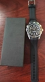 Macro shot of a men's diving watch with black wave dial and rubber strap on wood surface - Black With Box