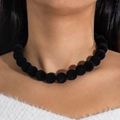 Détail du collier de perles en velours noir sur modèle soulignant la texture douce - Noir Floqué