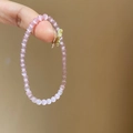 Detail of pink cat-eye stone bead bracelet with a golden butterfly pendant charm - 4mm Round Beads (with Gold Butterfly Pendant) / Pink Cat Eye Stone