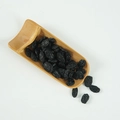 Artificial blackcurrant raisins model in a bamboo spoon container on white background - Dried Blackcurrants (500g)
