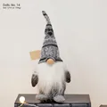 Grey Christmas gnome plush with snowflake knitted hat standing on a vintage book - Grey Nordic Snowflake (Doll No. 14)