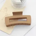 Detail of matte caramel square hair claw clip with large rectangular hollow design - Earth Yellow