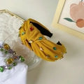 Yellow fabric knotted headband featuring colorful rhinestones in a baroque style - Orange