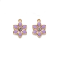 Detailed macro view of purple enamel flower pendants with sparkling white crystals - Purple
