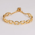 Detailed close-up of golden linked heart-shaped bracelet with lobster clasp and chain - Gold