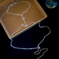 Detail of silver body chain featuring rhinestones and a cross pendant with lobster clasp - Silver