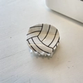 Detail shot of a round hair claw clip with a realistic black and white volleyball pattern - Small Volleyball (5cm)