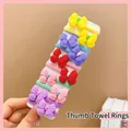 Close-up of 10 colorful elastic thumb towel hair ties with cute plastic bow ornaments - Butterfly Knot (10 Pcs)