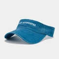 Detail of blue washed cotton sun visor with white Not Interested embroidery and curved brim - Adjustable / Lake Blue