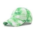 Detail of green tie-dye baseball cap featuring white star patterns and curved brim - Green