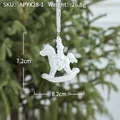 White glitter rocking horse Christmas tree ornament with ribbon hanging on green branch - White Horse