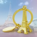 Polished golden Eiffel Tower keychain with round metal tag and 3D architectural details - Eiffel Tower / Gold