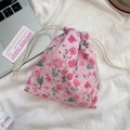 Macro shot of pink floral drawstring storage pouch with soft cotton fabric texture - Lusi Portrait