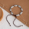 Ethnic handmade braided bracelet with silver fish beads and adjustable brown cord - 9 Small Fish Bracelet