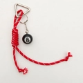 Detailed close-up of a black billiard No. 8 ball keychain with red and white woven cord - Red Rope + Billiards 8 Ball