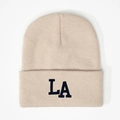 Detailed view of the 3D LA embroidery on a cream ribbed knit beanie hat - Beige