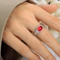 Silver wavy ring band featuring an oval red gemstone inlay with professional macro detail - Ring / Steel Red Crystal / US 7