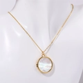 Golden necklace with a round mother of pearl butterfly pendant on white mannequin - Round / Gold