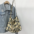 Close-up of large daisy print canvas tote bag with black background and shoulder strap - Daisy Black