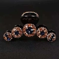 Rhinestone claw clip with deep blue and amber gemstones on dark plastic base - Enchanting Star Blue