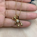 Detailed view of a golden bear pendant with sparkling zircons held by a hand - Full Zirconia Style (I)