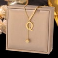 Detail of gold titanium letter Q necklace with cube pendant on jewelry box - Letter Q-Gold