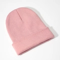 Detailed close-up showing the fine knit texture and folded cuff of this pink beanie - Dusky Pink