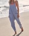 Detail of light blue loose jumpsuit with large pockets on an outdoor beach setting - Light Blue