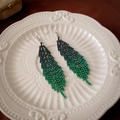 Detailed macro view of long feather earrings featuring gradient blue and green rhinestones - Green Rhinestone Feather Earhook