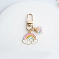 Cute rainbow and heart metal keychain with glass ball pendant on a white ceramic plate - Round Buckle