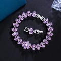 Macro shot of silver bracelet featuring purple teardrop zircons in a floral design - Purple