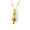 Close-up of a minimalist golden oval pendant on a classic chain with a polished finish - Letter I