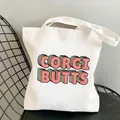 White canvas tote bag featuring retro Corgi Butts colorful graphic print on a chair - C1-Corgi Butts