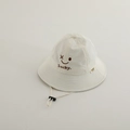 Close-up of white sun hat with brown smiley face embroidery and adjustable windproof cord - Closed Eyes Smiley / Off White