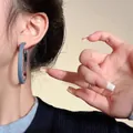 Exaggerated silver circle hoop earrings wrapped in blue denim fabric for a stylish look - Denim Texture Patchwork Hoop / Light Blue