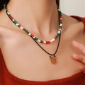 Close-up of double-layered Christmas necklace with festive beads and reindeer charm - D1234 Double Layer Red Nose Elk Pendant