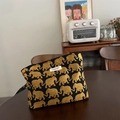 Detaillierte Sticktextur des goldenen Elefantenmusters auf schwarzer Stoff-Kosmetiktasche - Schwarz Mit Goldener Elefant