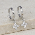 Detailed macro view of S925 sterling silver hoop earrings with zircon flower charms - Silver - White Zirconia