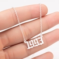 Macro detail of gothic style 1993 birth year pendant on a stainless steel chain - 1993 / Steel