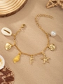 Gold ocean bracelet featuring pearl, starfish, shell charms and letter F on tan fabric - Letter F(F)