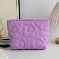 Detail of purple floral quilted makeup bag with soft texture and floral stitching - Violet