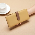 Long yellow pebble leather wallet with brown buckle strap and gold zipper details - Yellow