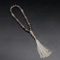 Natural agate prayer beads bracelet with cream tassel on a professional dark background - Grey Agate